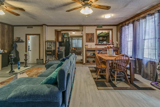 2317 N Redmond Ave, Bethany, OK 73008 - living room featuring a ceiling fan, a textured ceiling, and wood finished floors