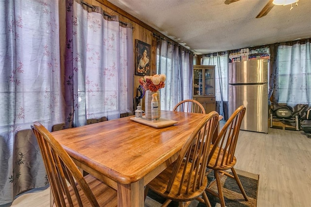 2317 N Redmond Ave, Bethany, OK 73008 - dining space featuring a textured ceiling, a ceiling fan, and light wood finished floors