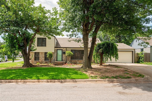 1200 NW 95th St, Oklahoma City, OK 73114 - split level home with a garage, concrete driveway, stone siding, and a front lawn