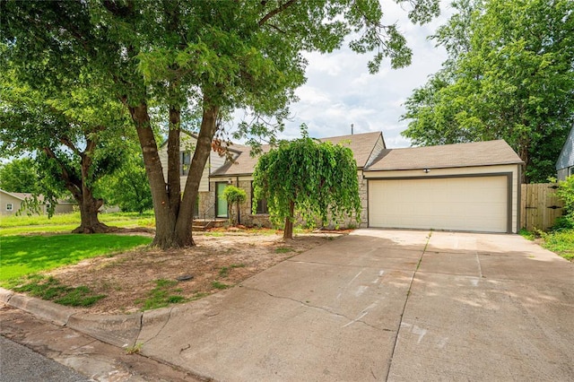 1200 NW 95th St, Oklahoma City, OK 73114 - view of property hidden behind natural elements featuring concrete driveway, a garage, stone siding, and a front yard