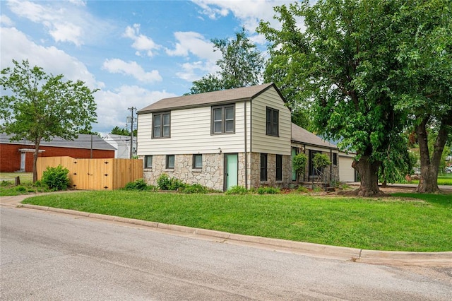 1200 NW 95th St, Oklahoma City, OK 73114 - split level home with stone siding, a garage, and a gate