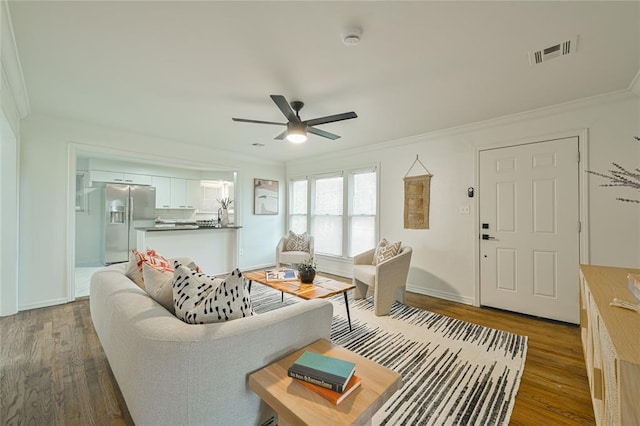 1200 NW 95th St, Oklahoma City, OK 73114 - living area with crown molding, a ceiling fan, and dark wood-style floors