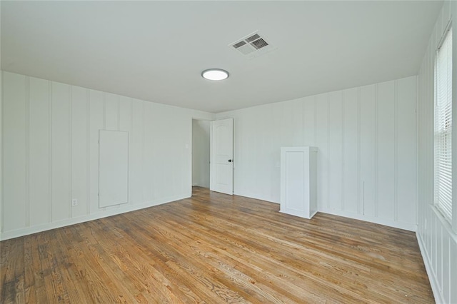 1200 NW 95th St, Oklahoma City, OK 73114 - empty room with light wood-type flooring and a decorative wall