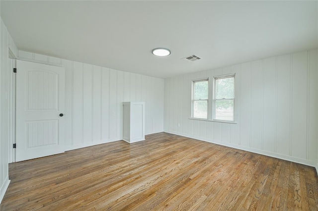1200 NW 95th St, Oklahoma City, OK 73114 - spare room with hardwood / wood-style floors and a decorative wall