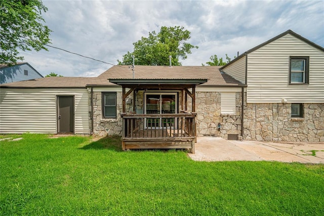1200 NW 95th St, Oklahoma City, OK 73114 - back of property featuring stone siding, a yard, a shingled roof, and a patio