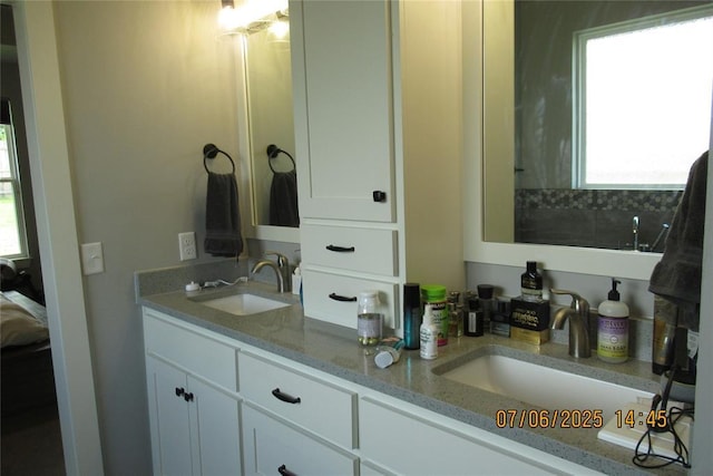 3909 Sorano Dr, Moore, OK 73160 - ensuite bathroom with plenty of natural light and double vanity