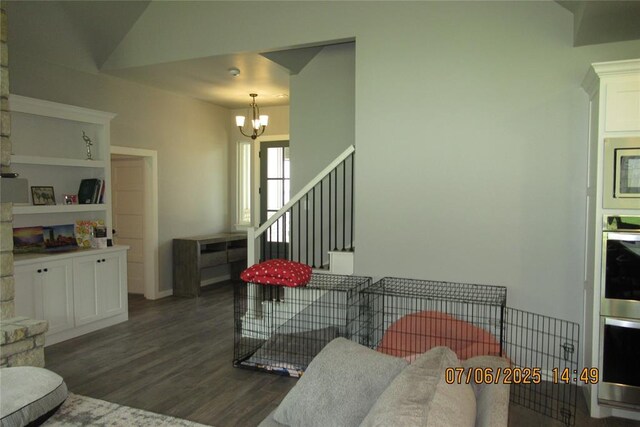 3909 Sorano Dr, Moore, OK 73160 - living area with a chandelier, dark wood-style floors, and stairway