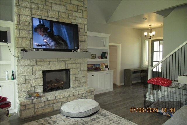 3909 Sorano Dr, Moore, OK 73160 - living area with a chandelier, wood finished floors, a fireplace, lofted ceiling, and stairs