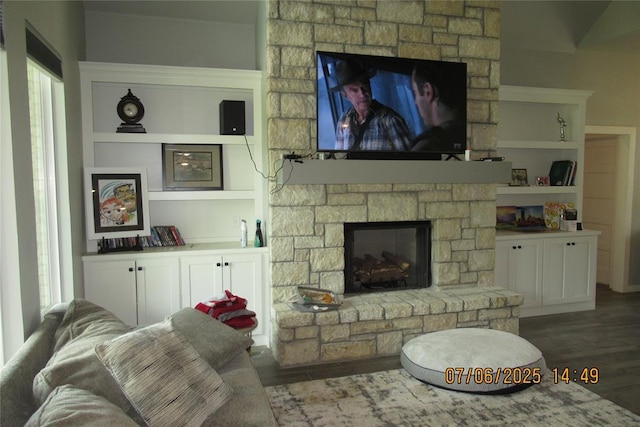 3909 Sorano Dr, Moore, OK 73160 - living area featuring a stone fireplace, wood finished floors, healthy amount of natural light, and built in shelves