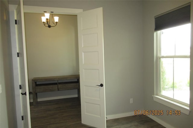 3909 Sorano Dr, Moore, OK 73160 - empty room with a chandelier and dark wood-type flooring