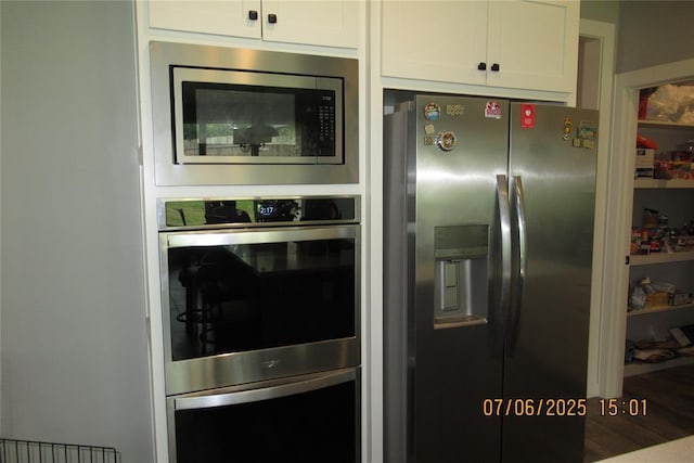 3909 Sorano Dr, Moore, OK 73160 - kitchen with appliances with stainless steel finishes and white cabinets