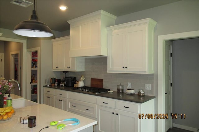 3909 Sorano Dr, Moore, OK 73160 - kitchen featuring stainless steel gas stovetop, white cabinets, backsplash, and recessed lighting