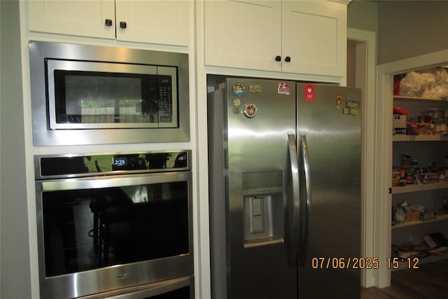 3909 Sorano Dr, Moore, OK 73160 - kitchen with appliances with stainless steel finishes and white cabinets