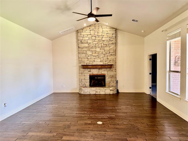 2803 Hidden Prairie Way, Edmond, OK 73013 - unfurnished living room with ceiling fan, vaulted ceiling, wood finished floors, a stone fireplace, and plenty of natural light