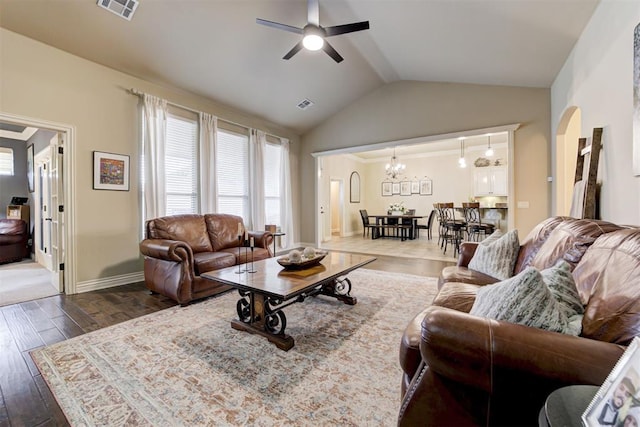 2803 Hidden Prairie Way, Edmond, OK 73013 - living area with ceiling fan, vaulted ceiling, wood finished floors, arched walkways, and a chandelier