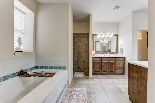 2803 Hidden Prairie Way, Edmond, OK 73013 - full bath with vanity, a bath, a chandelier, and walk in shower