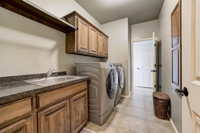 2803 Hidden Prairie Way, Edmond, OK 73013 - laundry room with cabinet space, washing machine and clothes dryer, and light tile patterned floors