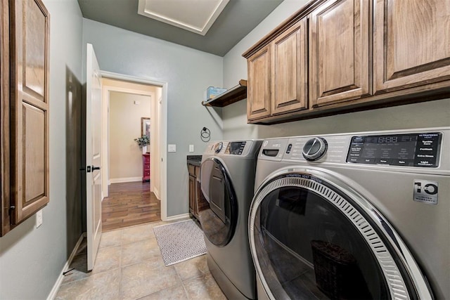 2803 Hidden Prairie Way, Edmond, OK 73013 - washroom featuring cabinet space, washer and dryer, and light tile patterned floors