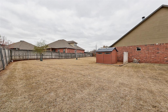 2803 Hidden Prairie Way, Edmond, OK 73013 - fenced backyard with a storage unit