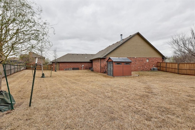 2803 Hidden Prairie Way, Edmond, OK 73013 - fenced backyard with a storage shed