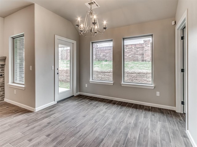 600 Mirano Ln, Edmond, OK 73034 - unfurnished dining area with a chandelier, light wood-style floors, and vaulted ceiling