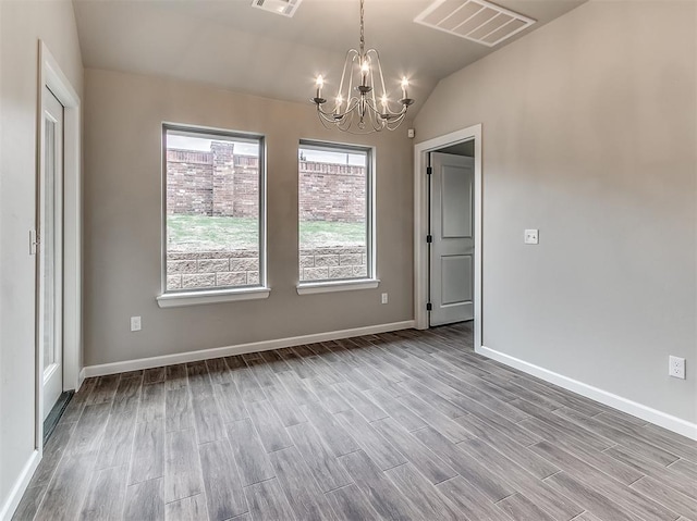 600 Mirano Ln, Edmond, OK 73034 - unfurnished dining area featuring a chandelier, wood finished floors, and lofted ceiling