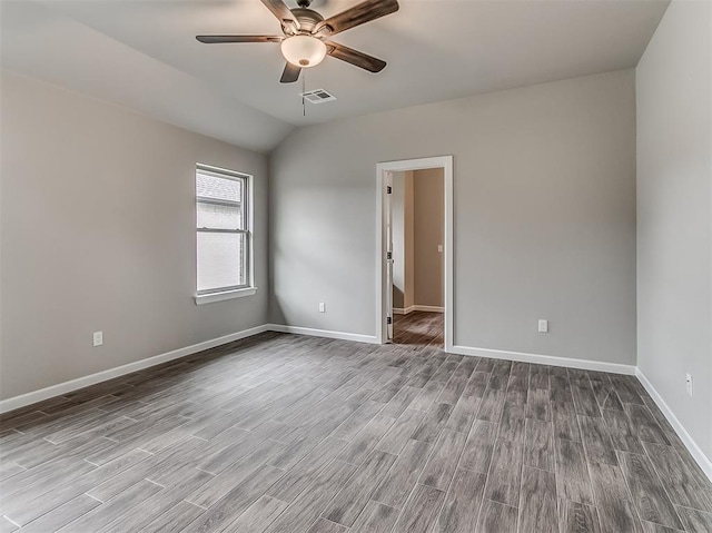 600 Mirano Ln, Edmond, OK 73034 - spare room featuring wood finished floors, a ceiling fan, and vaulted ceiling