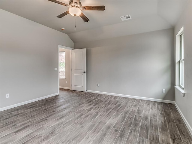 600 Mirano Ln, Edmond, OK 73034 - empty room featuring vaulted ceiling, ceiling fan, wood finished floors, and a smoke detector