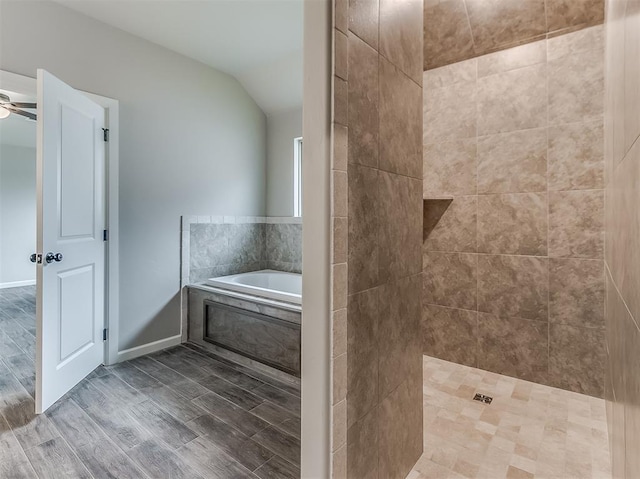 600 Mirano Ln, Edmond, OK 73034 - full bath with a garden tub, vaulted ceiling, a tile shower, a ceiling fan, and wood finished floors