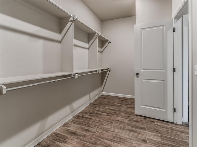 600 Mirano Ln, Edmond, OK 73034 - walk in closet with dark wood-style flooring