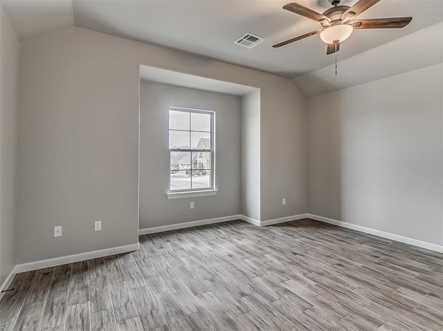 600 Mirano Ln, Edmond, OK 73034 - unfurnished room with lofted ceiling, a ceiling fan, and wood finished floors