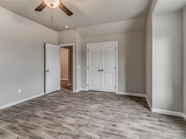 600 Mirano Ln, Edmond, OK 73034 - unfurnished bedroom with wood finished floors, a closet, and ceiling fan