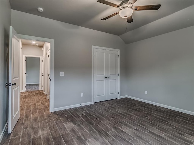 600 Mirano Ln, Edmond, OK 73034 - unfurnished bedroom featuring dark wood finished floors, a closet, vaulted ceiling, and ceiling fan