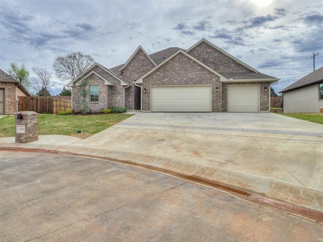 600 Mirano Ln, Edmond, OK 73034 - view of front of home with an attached garage, concrete driveway, and brick siding