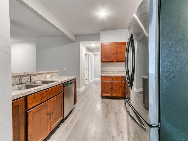 11104 NW 99th St, Yukon, OK 73099 - kitchen with stainless steel appliances, brown cabinetry, light wood-style flooring, light countertops, and beam ceiling