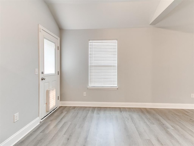 11104 NW 99th St, Yukon, OK 73099 - unfurnished room featuring light wood-style floors, healthy amount of natural light, and lofted ceiling