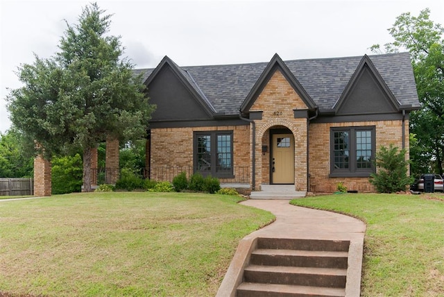 826 NE 18th St, Oklahoma City, OK 73105 - tudor-style house featuring brick siding and roof with shingles