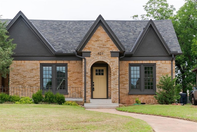 826 NE 18th St, Oklahoma City, OK 73105 - view of front of house with brick siding, roof with shingles, and a front lawn