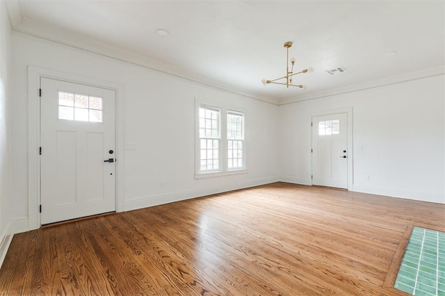 826 NE 18th St, Oklahoma City, OK 73105 - foyer entrance with ornamental molding, a chandelier, healthy amount of natural light, and wood finished floors
