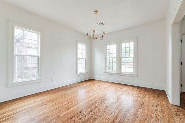 826 NE 18th St, Oklahoma City, OK 73105 - spare room featuring healthy amount of natural light, a chandelier, and wood finished floors