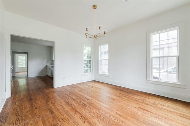 826 NE 18th St, Oklahoma City, OK 73105 - empty room with a chandelier, healthy amount of natural light, and wood finished floors