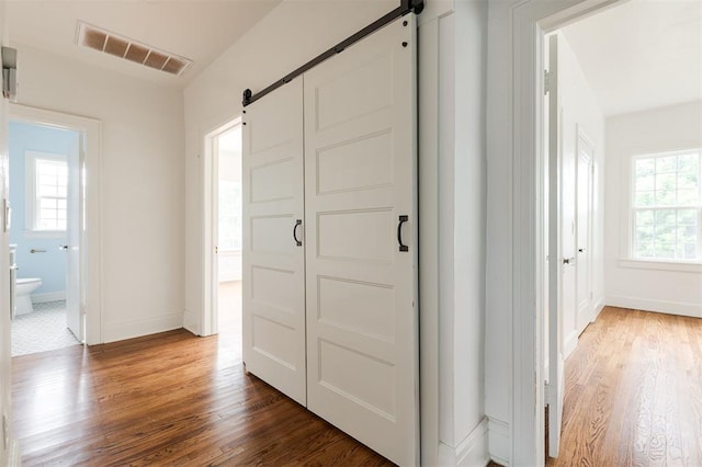 826 NE 18th St, Oklahoma City, OK 73105 - foyer with a barn door and wood finished floors