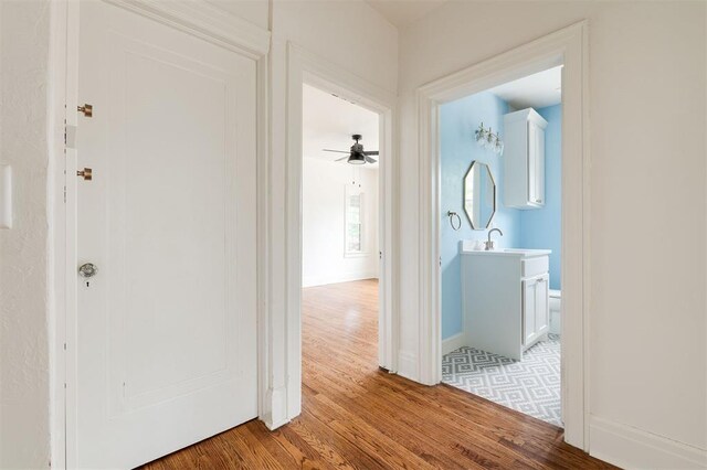 826 NE 18th St, Oklahoma City, OK 73105 - corridor with light wood-type flooring and a sink
