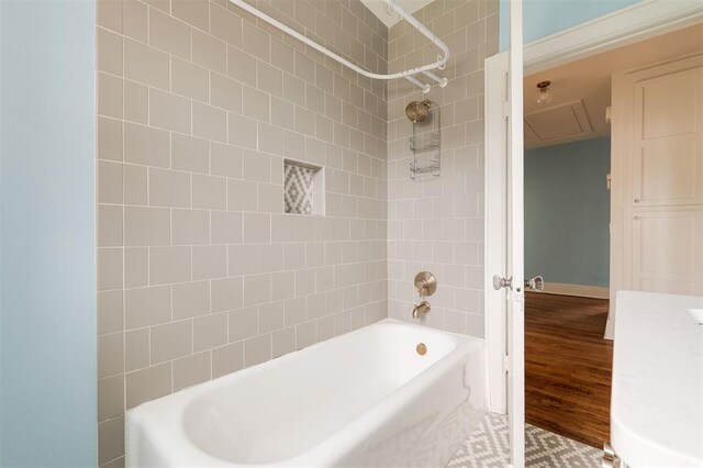 826 NE 18th St, Oklahoma City, OK 73105 - full bath featuring shower / bathtub combination, wood finished floors, and vanity