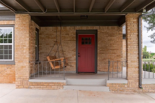 826 NE 18th St, Oklahoma City, OK 73105 - doorway to property with covered porch and brick siding