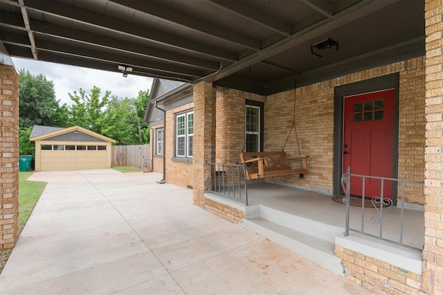 826 NE 18th St, Oklahoma City, OK 73105 - property entrance with a porch, brick siding, and a garage