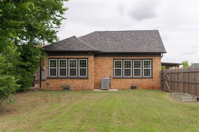 826 NE 18th St, Oklahoma City, OK 73105 - rear view of property featuring brick siding and a shingled roof