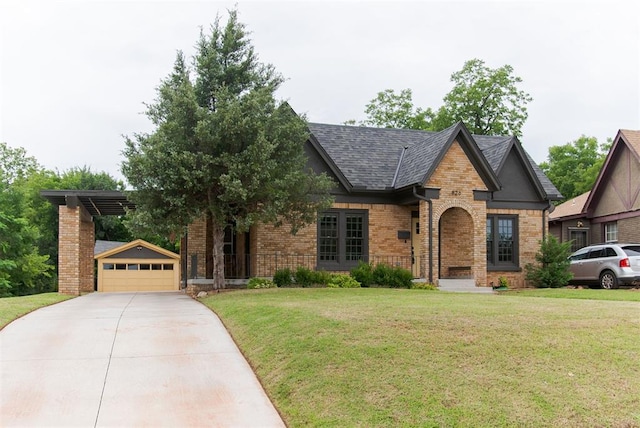 826 NE 18th St, Oklahoma City, OK 73105 - view of front of property featuring brick siding, a front lawn, an outdoor structure, driveway, and a detached garage
