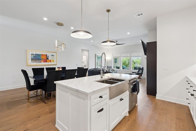 209 Pont Neuf Ct, Edmond, OK 73034 - kitchen with recessed lighting, dishwasher, light wood-style floors, an island with sink, and white cabinetry