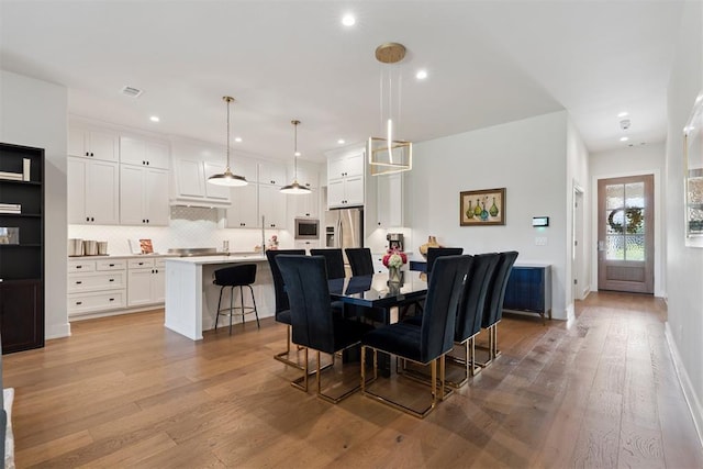 209 Pont Neuf Ct, Edmond, OK 73034 - dining space with light wood finished floors and recessed lighting
